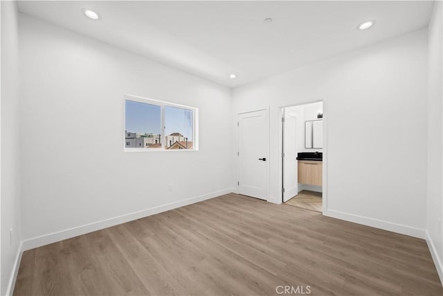 648 N Boyle Ave, Los Angeles, CA 90033 - unfurnished bedroom with baseboards, light wood finished floors, connected bathroom, and recessed lighting
