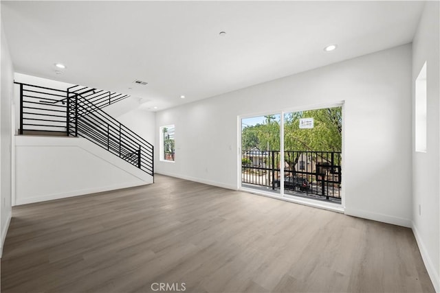 648 N Boyle Ave, Los Angeles, CA 90033 - unfurnished living room featuring stairway, wood finished floors, baseboards, and recessed lighting
