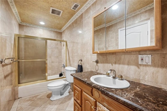 7980 Hollywood Way, Sun Valley, CA 91352 - full bathroom with tile walls, visible vents, tile patterned flooring, vanity, and combined bath / shower with glass door