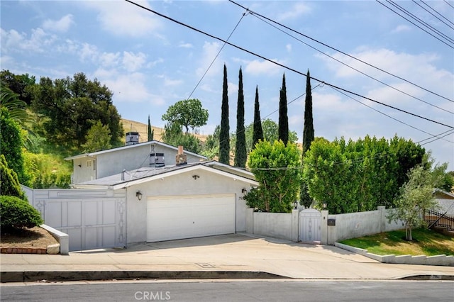 7980 Hollywood Way, Sun Valley, CA 91352 - view of front of house featuring a gate, an attached garage, driveway, stucco siding, and a fenced front yard