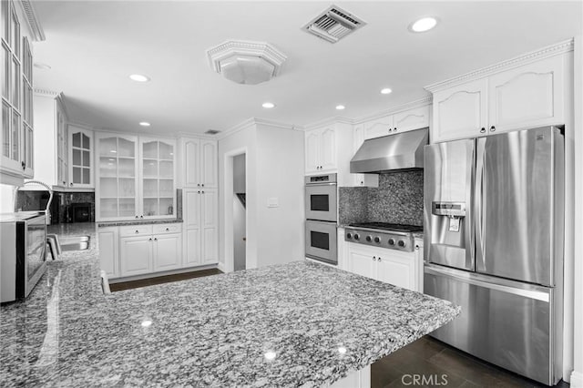 7980 Hollywood Way, Sun Valley, CA 91352 - kitchen featuring a peninsula, visible vents, under cabinet range hood, glass insert cabinets, and appliances with stainless steel finishes