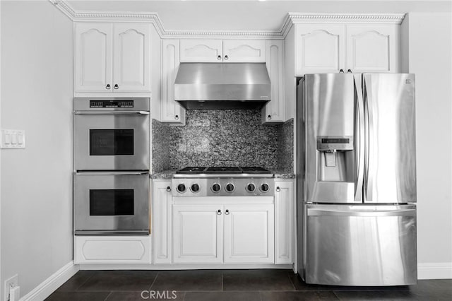 7980 Hollywood Way, Sun Valley, CA 91352 - kitchen with stainless steel appliances, white cabinetry, baseboards, backsplash, and under cabinet range hood