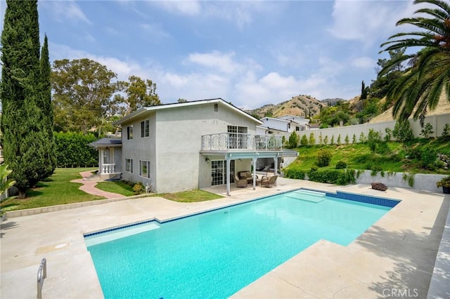 7980 Hollywood Way, Sun Valley, CA 91352 - back of property with a patio area, a mountain view, a balcony, stucco siding, and a fenced backyard