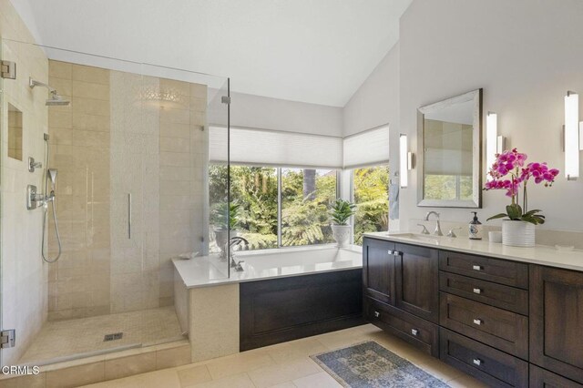 2113 Doral Ct, Oxnard, CA 93036 - full bath featuring vanity, high vaulted ceiling, tile patterned floors, a garden tub, and tiled shower