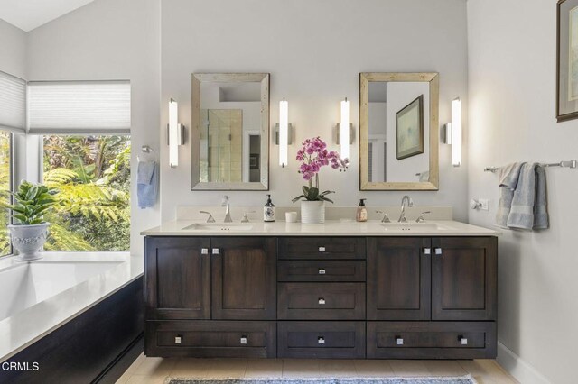 2113 Doral Ct, Oxnard, CA 93036 - full bathroom with a tile shower, double vanity, lofted ceiling, and baseboards