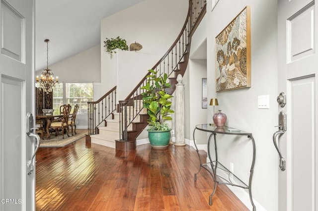 2113 Doral Ct, Oxnard, CA 93036 - foyer featuring stairs, high vaulted ceiling, an inviting chandelier, wood-type flooring, and baseboards