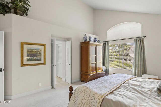 2113 Doral Ct, Oxnard, CA 93036 - bedroom with light carpet, baseboards, and high vaulted ceiling