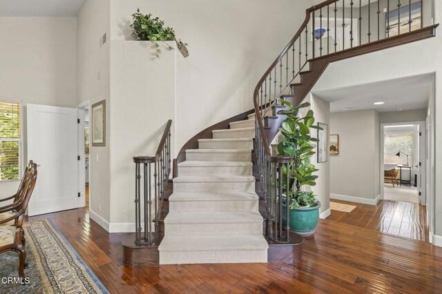 2113 Doral Ct, Oxnard, CA 93036 - stairs with a towering ceiling, wood-type flooring, and baseboards