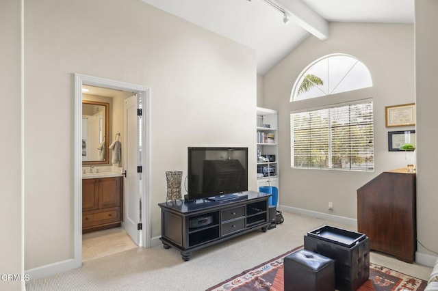 2113 Doral Ct, Oxnard, CA 93036 - carpeted living room featuring beam ceiling, high vaulted ceiling, baseboards, and a sink