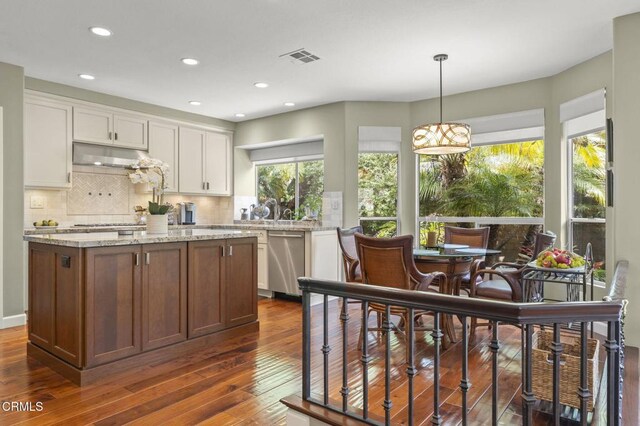 2113 Doral Ct, Oxnard, CA 93036 - kitchen with white cabinetry, decorative backsplash, dark wood-type flooring, and dishwasher