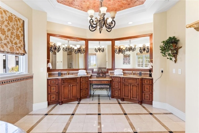 full bath featuring a tray ceiling, a chandelier, and a healthy amount of sunlight