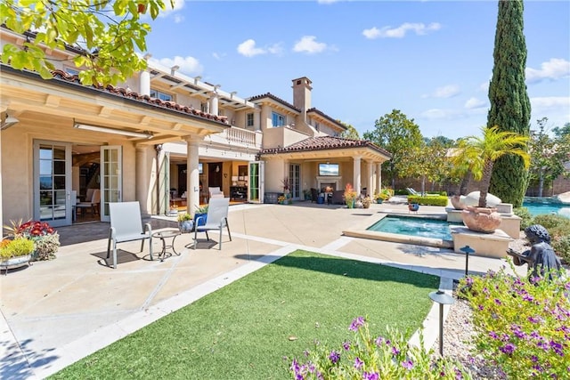 19 Fox Hole Rd, Ladera Ranch, CA 92694 - rear view of house featuring stucco siding, a chimney, and a patio area