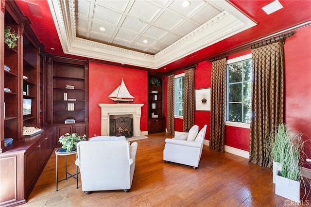 living room featuring a warm lit fireplace, recessed lighting, baseboards, crown molding, and light wood-type flooring