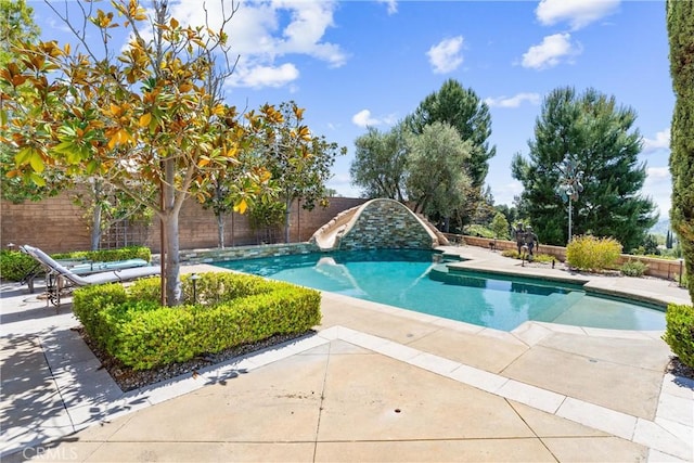 view of pool featuring a fenced backyard, a patio area, a water slide, and a fenced in pool