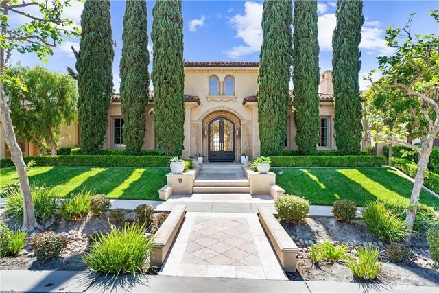 19 Fox Hole Rd, Ladera Ranch, CA 92694 - mediterranean / spanish-style home with french doors, stucco siding, and a front yard