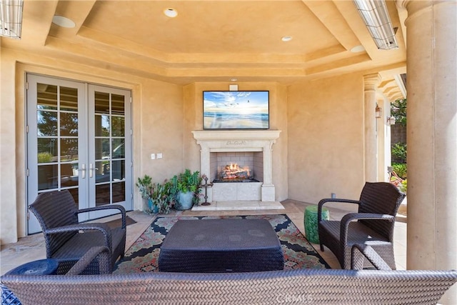 view of patio featuring an outdoor living space with a fireplace and french doors