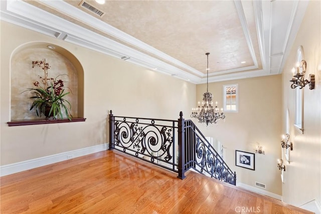 19 Fox Hole Rd, Ladera Ranch, CA 92694 - stairway with a chandelier, wood finished floors, and a raised ceiling