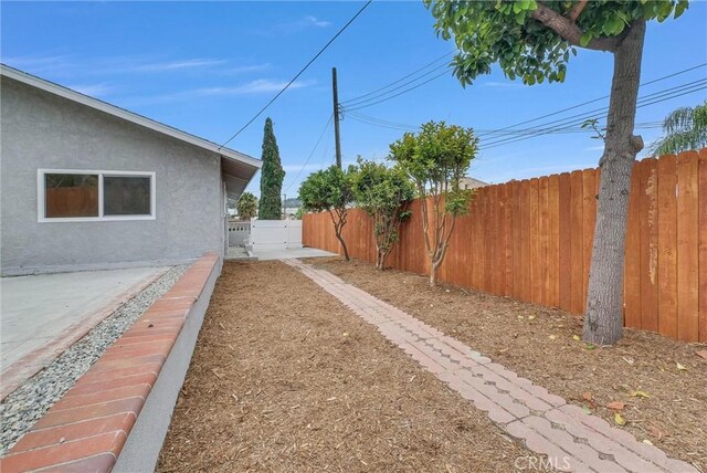 fenced backyard with a patio