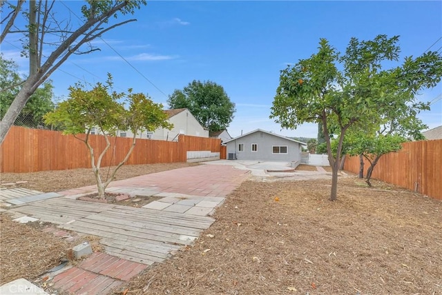 fenced backyard with a patio area