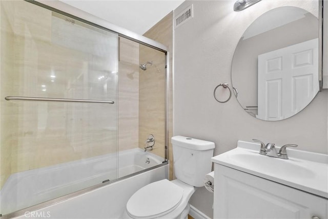 full bath featuring toilet, vanity, and combined bath / shower with glass door