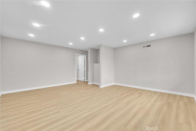 unfurnished room with recessed lighting, light wood-type flooring, and baseboards