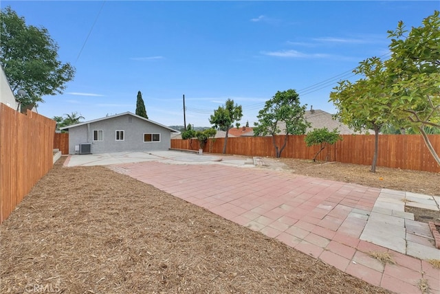 rear view of house featuring a patio area, a fenced backyard, and cooling unit