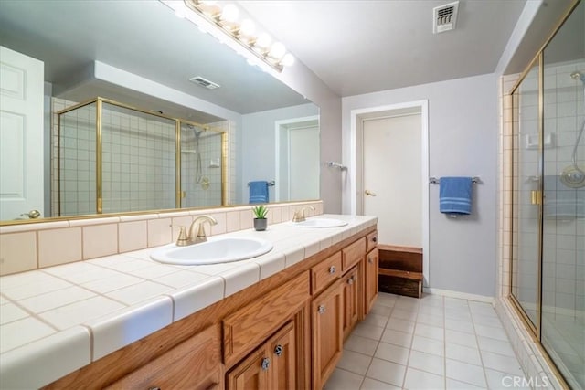 2322 Almond Springs Dr, Paso Robles, CA 93446 - full bath featuring double vanity, a stall shower, tile patterned floors, and baseboards