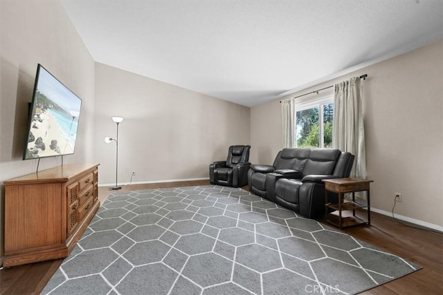 living area with baseboards and dark wood finished floors