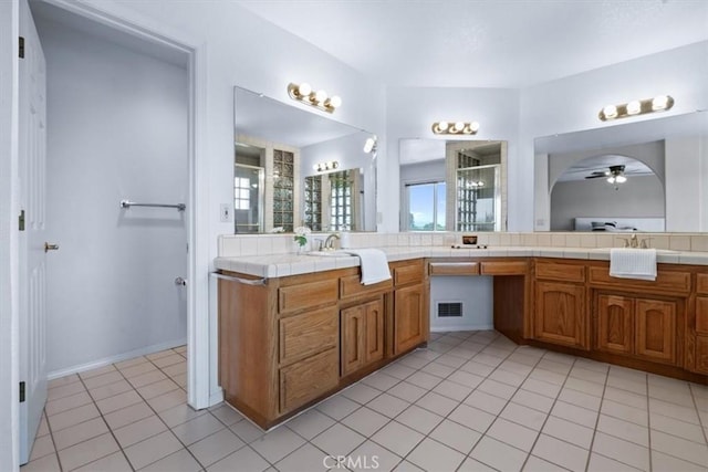 bathroom with a ceiling fan, a stall shower, plenty of natural light, and tile patterned floors