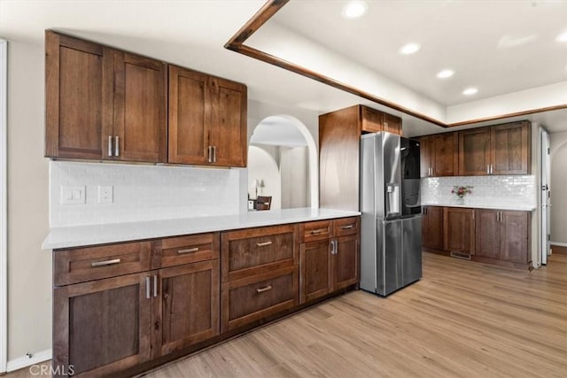 2322 Almond Springs Dr, Paso Robles, CA 93446 - kitchen with stainless steel refrigerator with ice dispenser, light wood-style floors, tasteful backsplash, light countertops, and recessed lighting