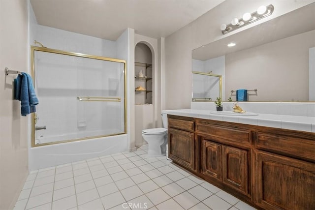 full bath with vanity, toilet, shower / bath combination with glass door, tile patterned flooring, and built in features