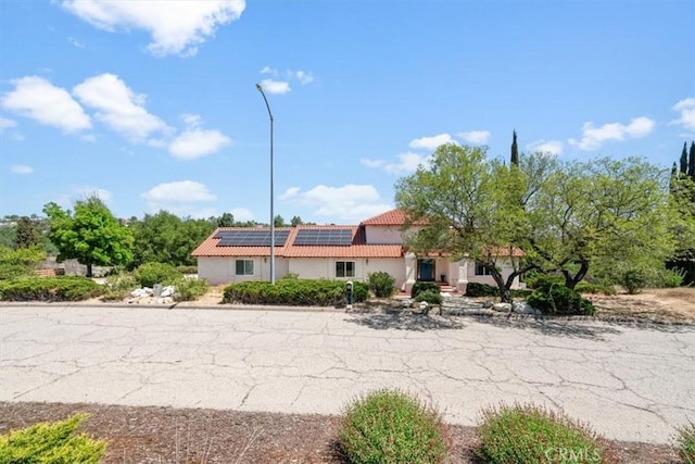 2322 Almond Springs Dr, Paso Robles, CA 93446 - view of front of home with a tile roof, solar panels, and stucco siding