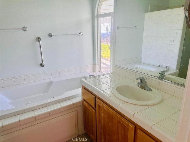 full bathroom with vanity and a jetted tub