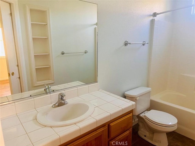 bathroom with toilet, shower / bathing tub combination, and vanity