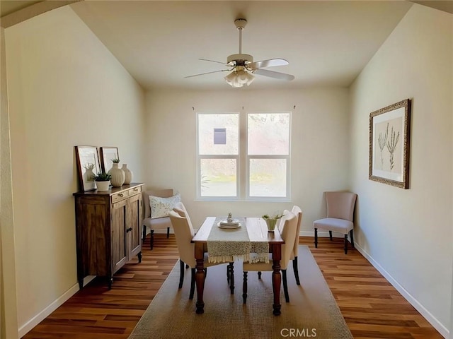 dining space featuring ceiling fan, baseboards, and wood finished floors