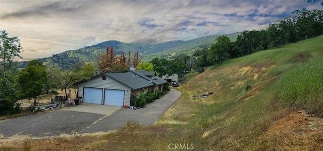 garage with a mountain view and driveway