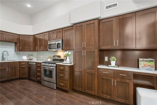 26511 Merienda Unit 7, Laguna Hills, CA 92656 - kitchen with stainless steel appliances, a sink, light countertops, decorative backsplash, and recessed lighting