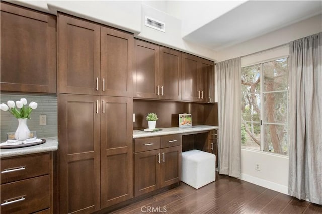 26511 Merienda Unit 7, Laguna Hills, CA 92656 - bar with decorative backsplash, baseboards, dark wood-style floors, and built in study area