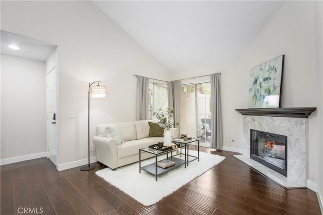 26511 Merienda Unit 7, Laguna Hills, CA 92656 - living area featuring baseboards, a high end fireplace, wood finished floors, and high vaulted ceiling