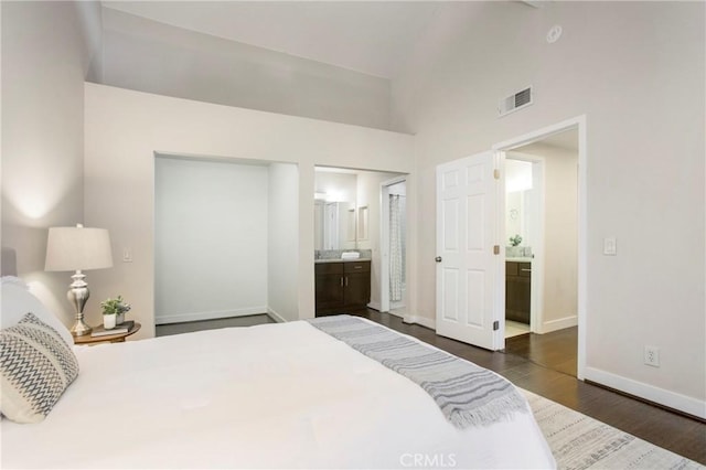 26511 Merienda Unit 7, Laguna Hills, CA 92656 - bedroom featuring ensuite bathroom, dark wood finished floors, baseboards, and high vaulted ceiling