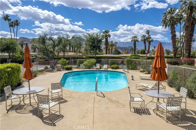 1 Valencia Dr, Rancho Mirage, CA 92270 - community pool with a mountain view, fence, and a patio area