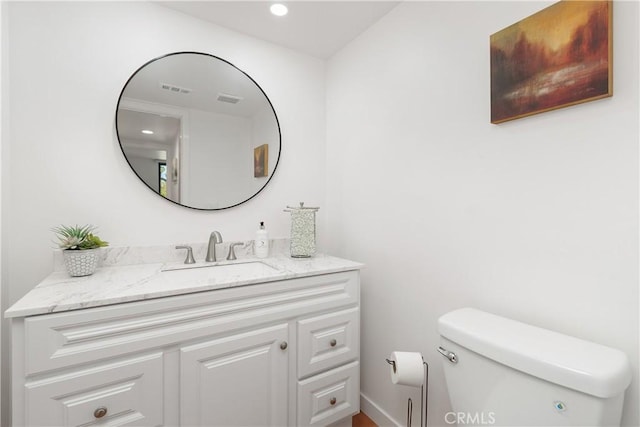 1 Valencia Dr, Rancho Mirage, CA 92270 - half bathroom with toilet, vanity, and recessed lighting