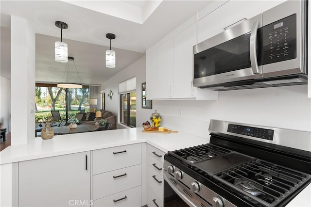 1 Valencia Dr, Rancho Mirage, CA 92270 - kitchen featuring appliances with stainless steel finishes, a peninsula, white cabinets, and light countertops