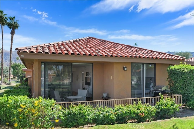 1 Valencia Dr, Rancho Mirage, CA 92270 - rear view of house with stucco siding and a tile roof