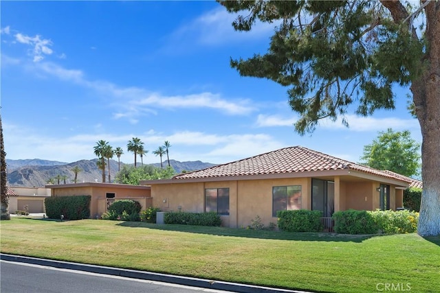 1 Valencia Dr, Rancho Mirage, CA 92270 - view of front of property featuring a mountain view, stucco siding, a front yard, and a tile roof