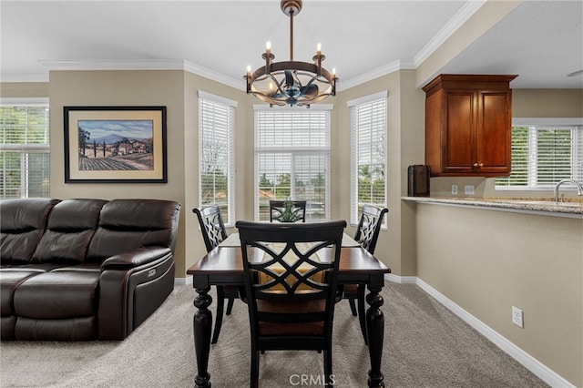 23412 Pacific Park Dr Unit 40H, Aliso Viejo, CA 92656 - carpeted dining area with a chandelier, baseboards, ornamental molding, and a sink