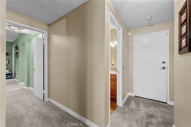 23412 Pacific Park Dr Unit 40H, Aliso Viejo, CA 92656 - hall featuring light carpet, a textured ceiling, and baseboards