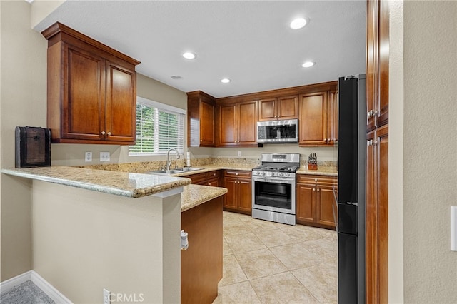 23412 Pacific Park Dr Unit 40H, Aliso Viejo, CA 92656 - kitchen featuring appliances with stainless steel finishes, a peninsula, a sink, recessed lighting, and light stone counters