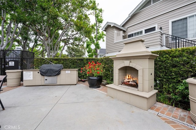 23412 Pacific Park Dr Unit 40H, Aliso Viejo, CA 92656 - view of patio featuring a fireplace and fence