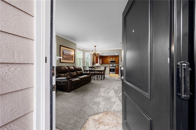 23412 Pacific Park Dr Unit 40H, Aliso Viejo, CA 92656 - living room with crown molding, light colored carpet, a chandelier, and light tile patterned floors